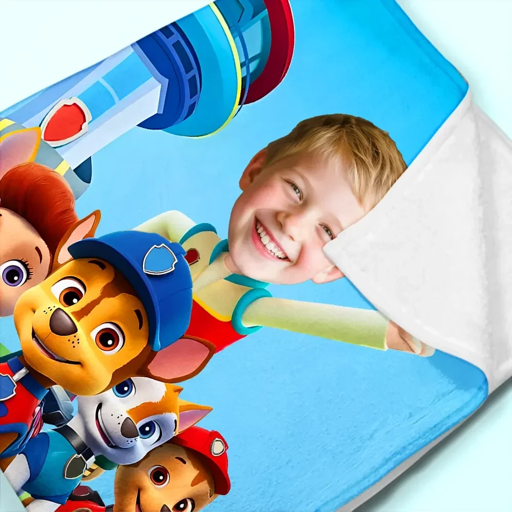 Close-up detail of a personalized photo blanket showing high-quality print of a child's face with cartoon characters