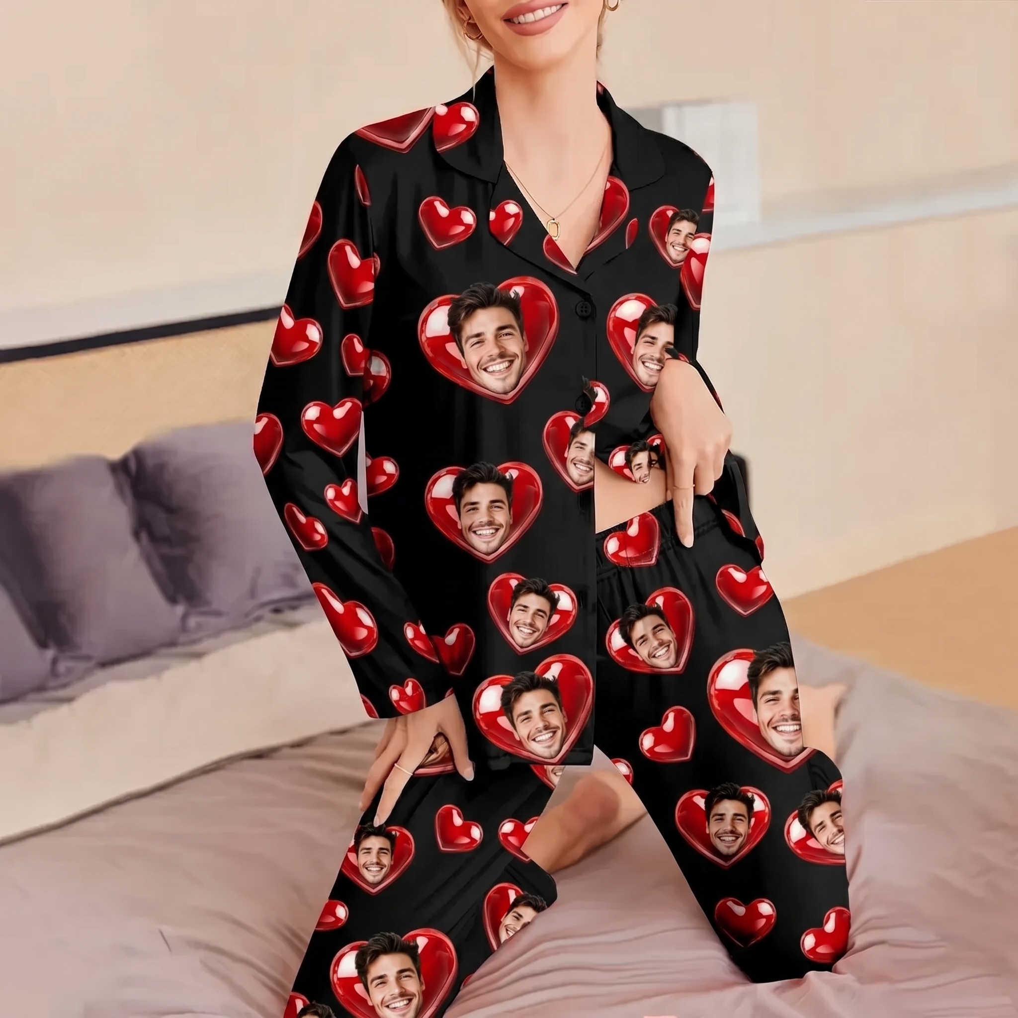Woman wearing customized black pajamas printed with a personal face photo in red hearts, sitting on a bed