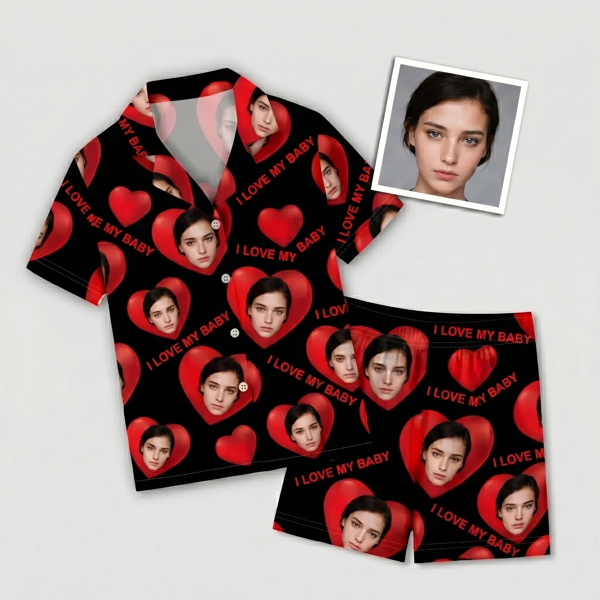 Flat lay of a custom face pajama short set, black fabric printed with red hearts and a personalized portrait