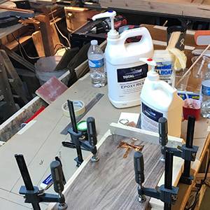 Handy TotalBoat High Performance 2:1 Epoxy Kits with come with gloves. stir sticks. and mixing cups.