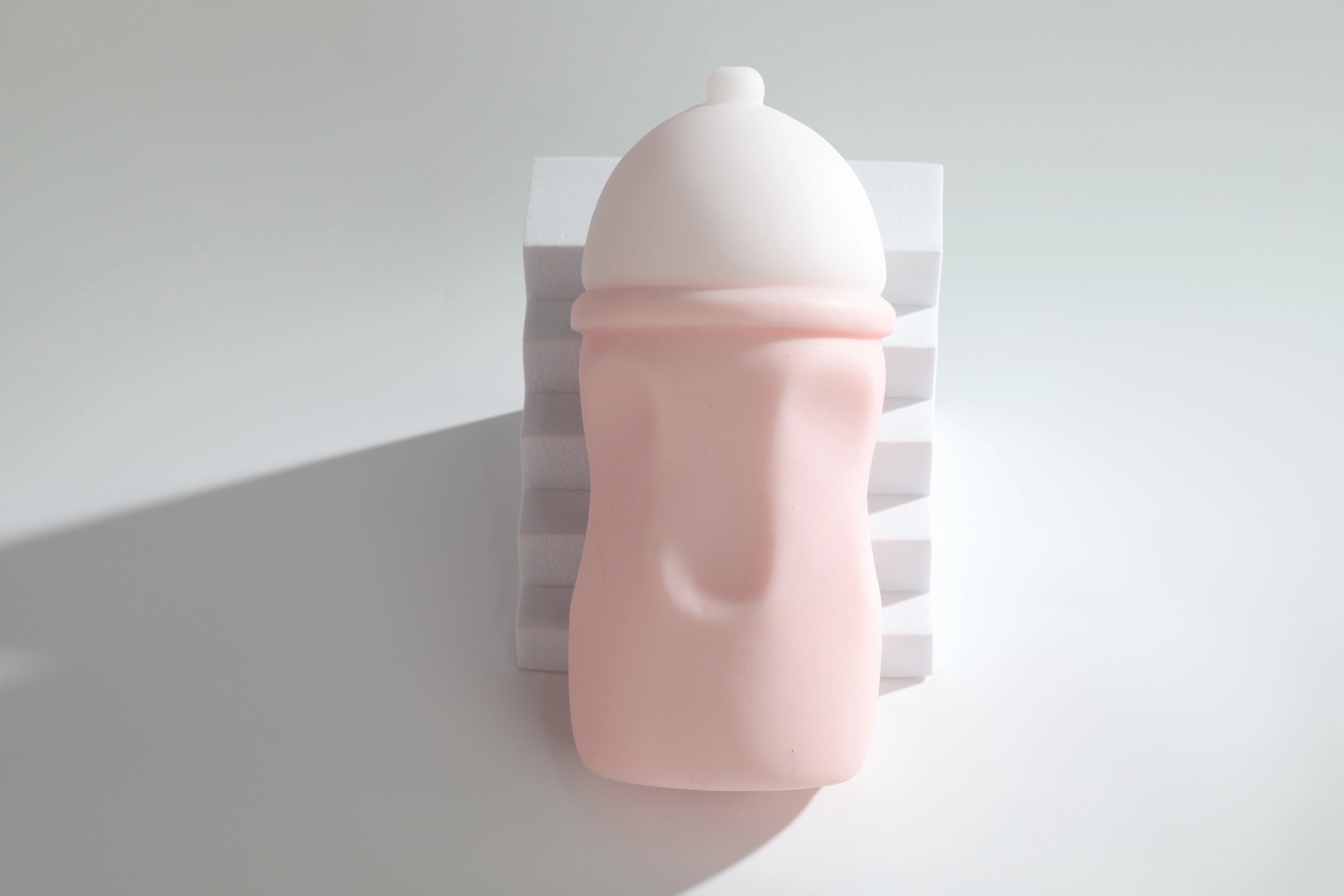 Layered two-tone breast-shaped design of the Dr.YUU manual stroker