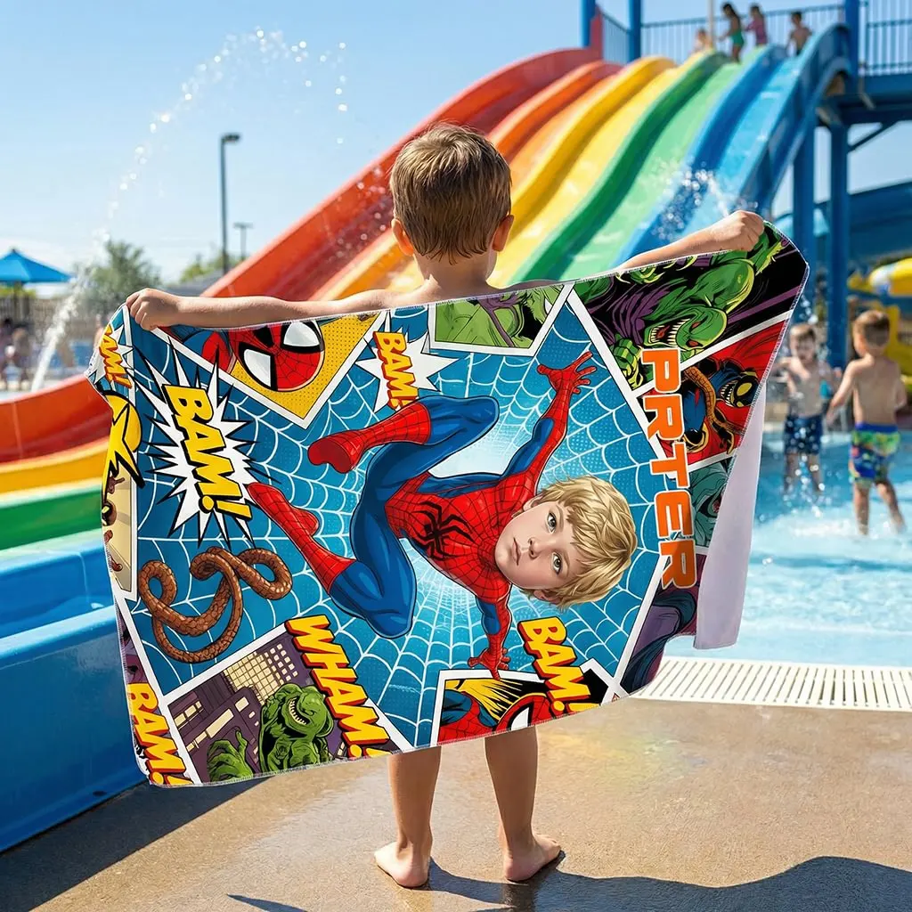 Little boy holding up his custom face superhero kids beach towel by the swimming pool