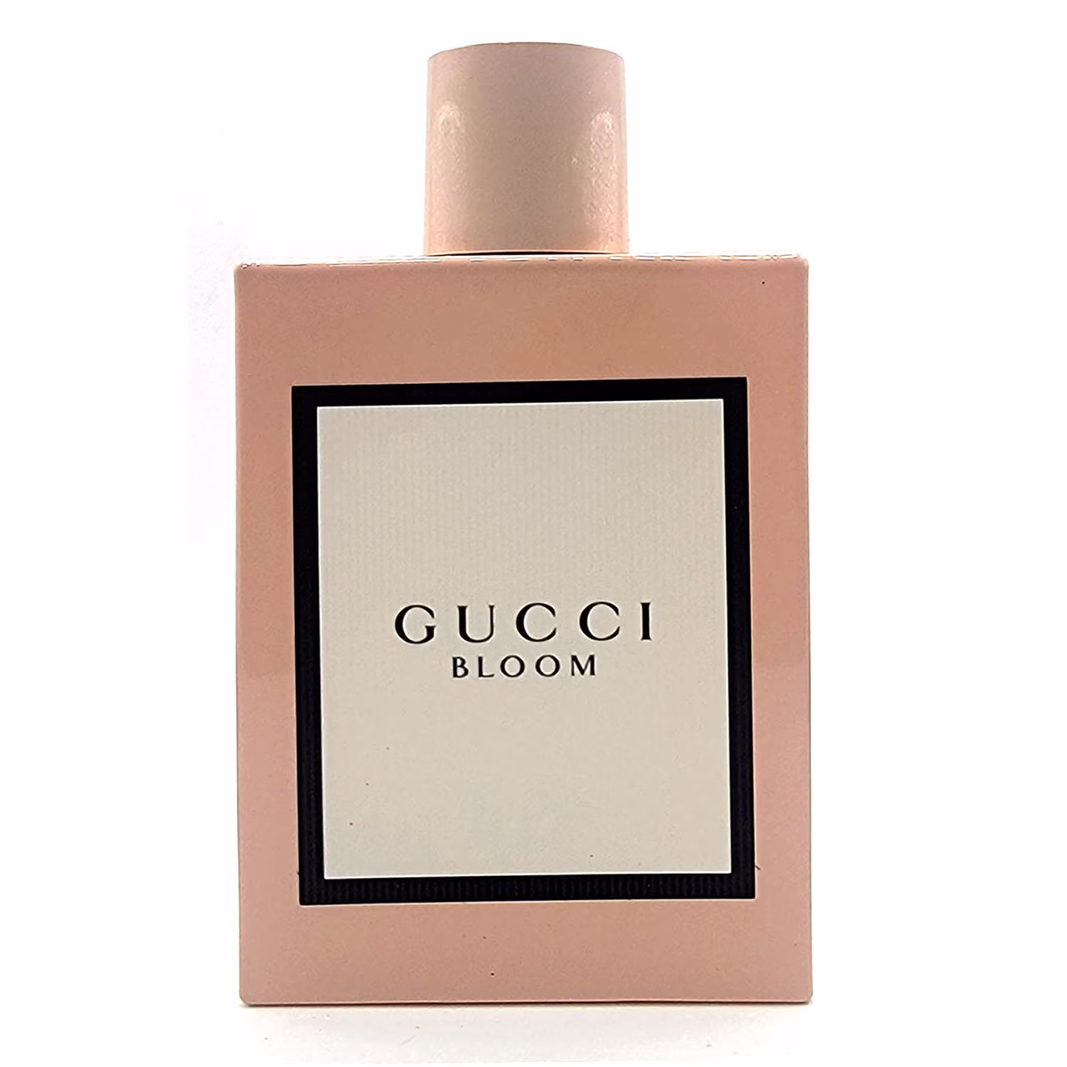 Close-up front view of the minimalist, porcelain-like pale pink Gucci Bloom Eau de Parfum bottle.